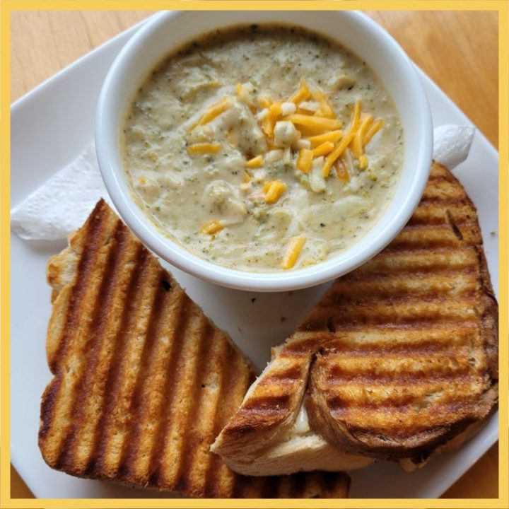 A bowl of soup and a grilled cheese sandwich