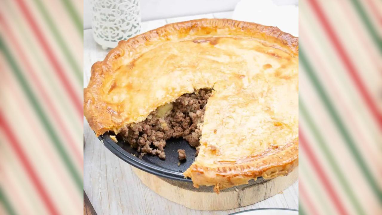 Traditional French Canadian meat pie with a slide cut out.